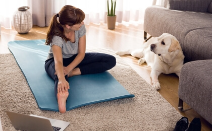 woman doing yoga with dog