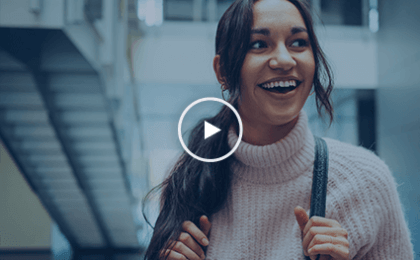 young person smiling wearing a backpack